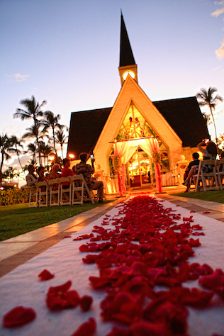 grand wailea chapel at night with rose petals on aisle