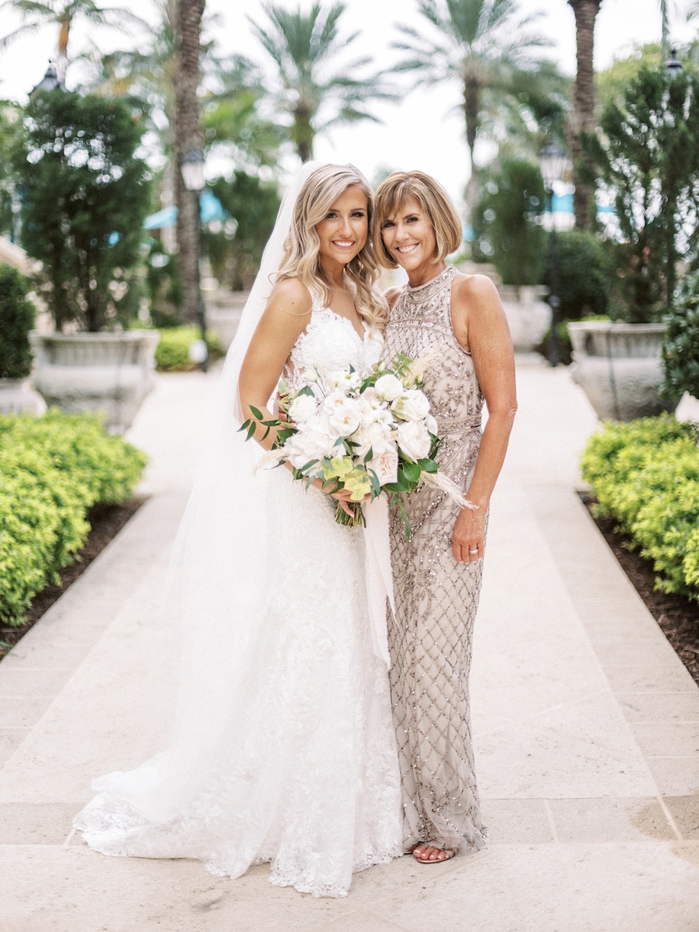 mother and daughter standing together on brides wedding day