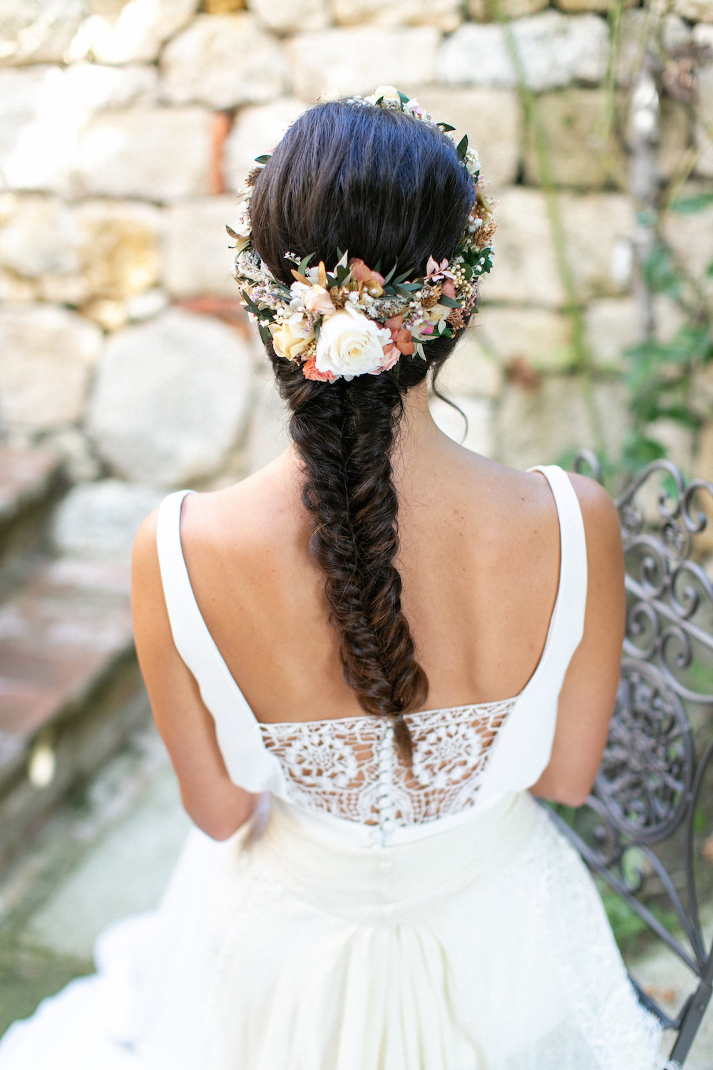 bride with flower crown and fishtail braid