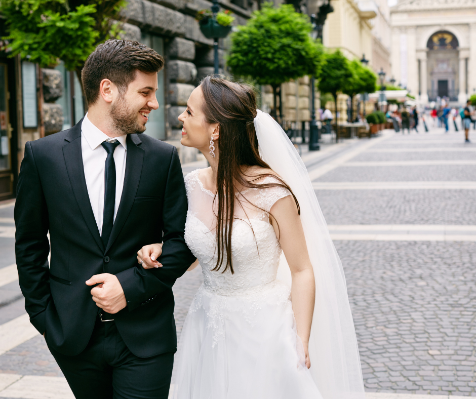bride and groom walking on cobblestone street