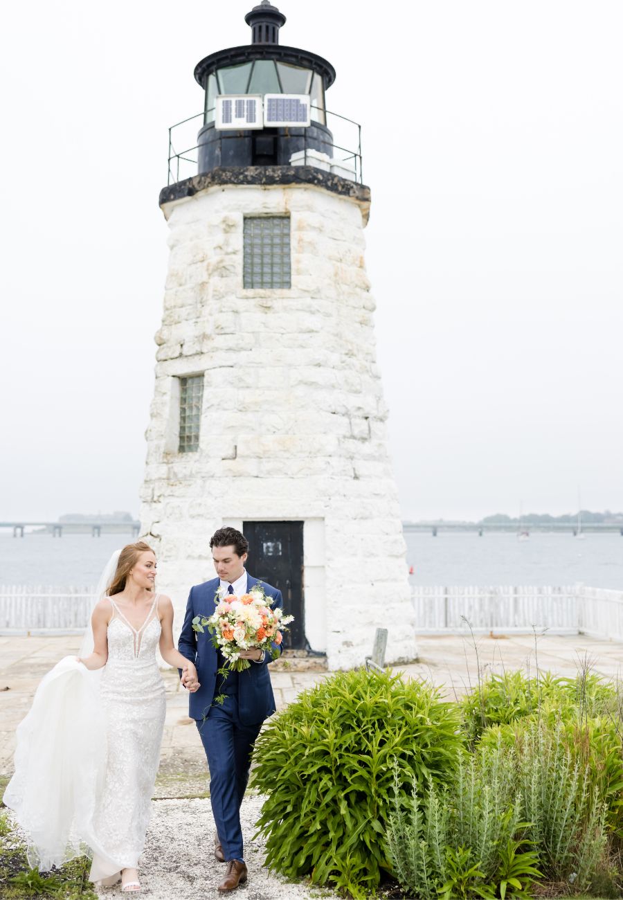 couple by light house