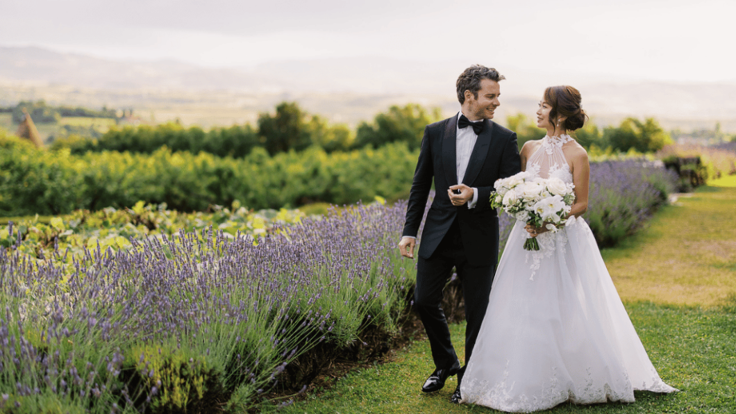 couple hold hands by lavender