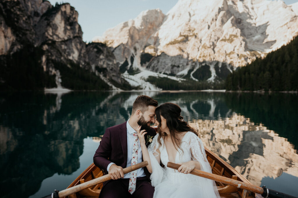 couple renewing vows in canoe by mountains