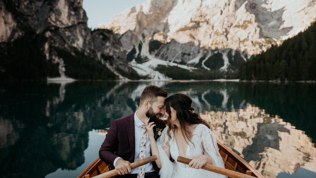 couple renewing vows in canoe by mountains