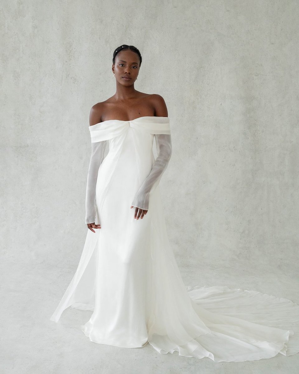 Model in strapless, sleeved wedding gown