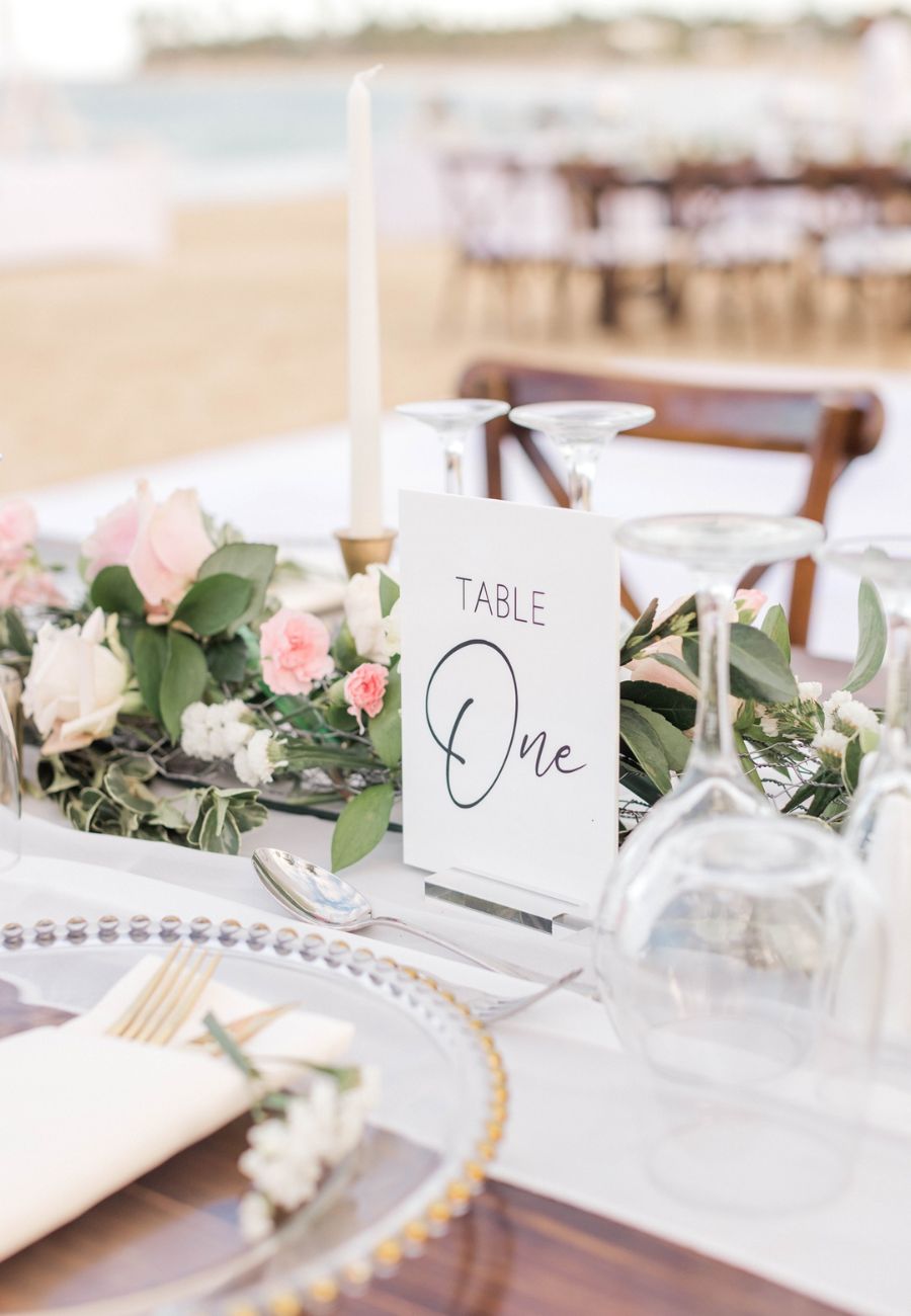 Reception table with centerpiece, tapered candle and table card