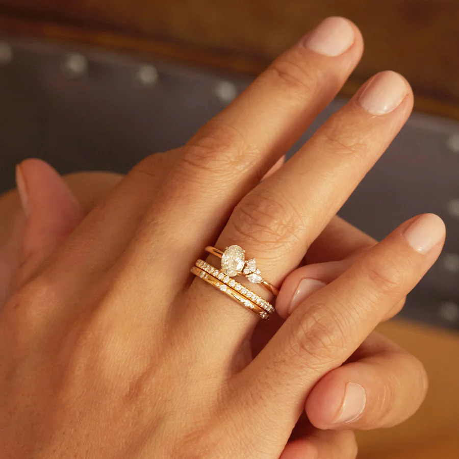 Hand wearing wedding ring set