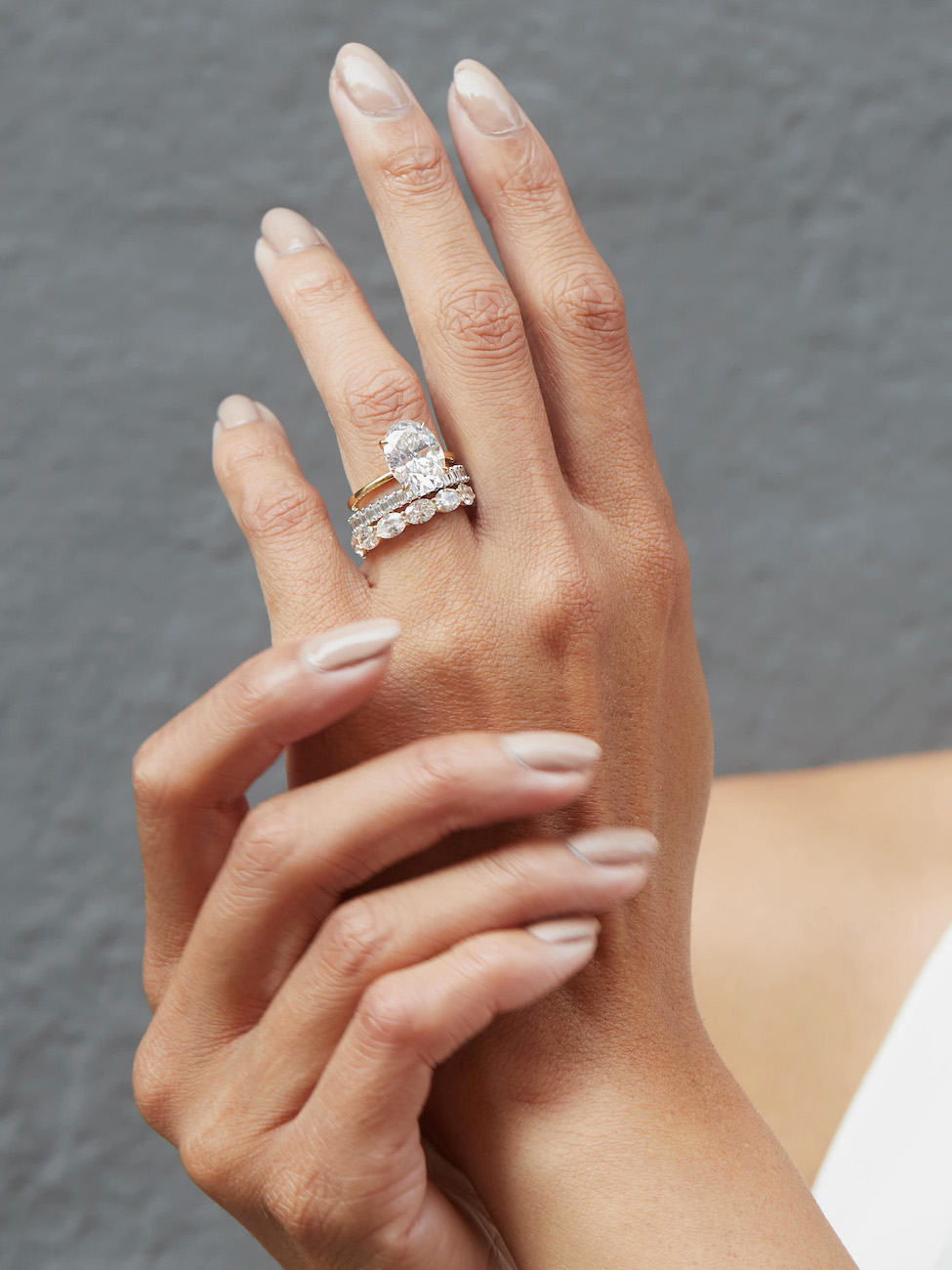 Female hand wearing three band wedding ring set
