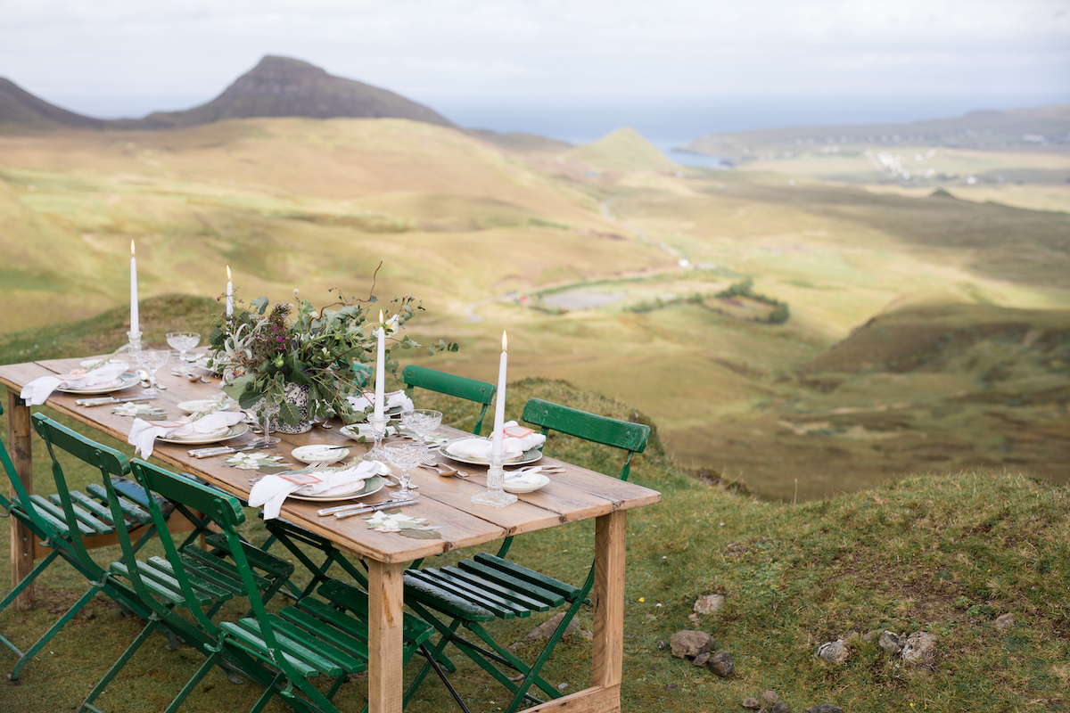 Charming picnic table wedding reception on rolling hills