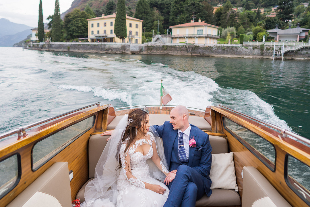 couple riding wooden boat on Lake Como