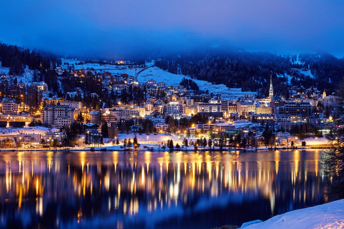 Snowy, nighttime photo of St. Moritz, Switzerland