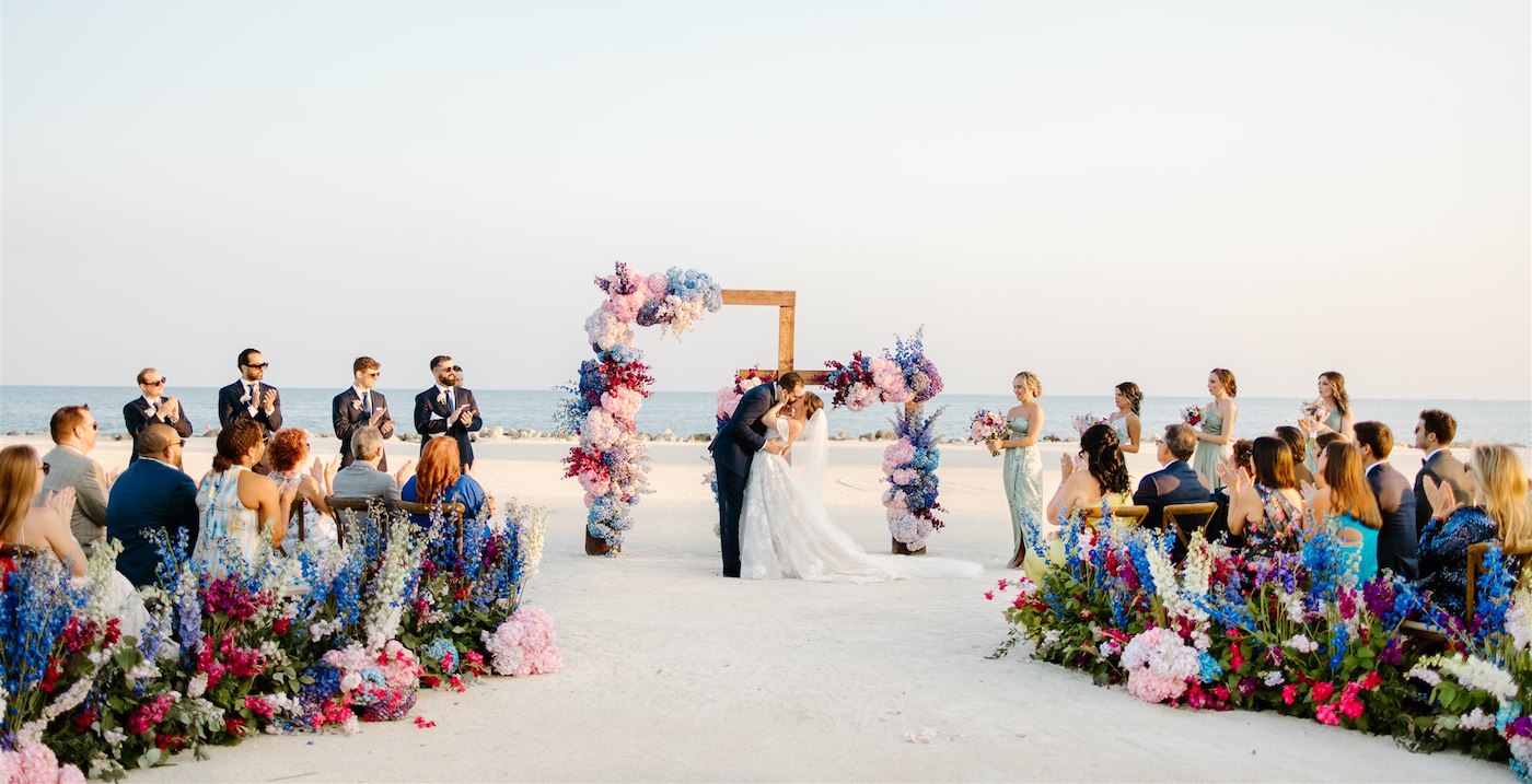 Wedding on the beach with colorful flowers