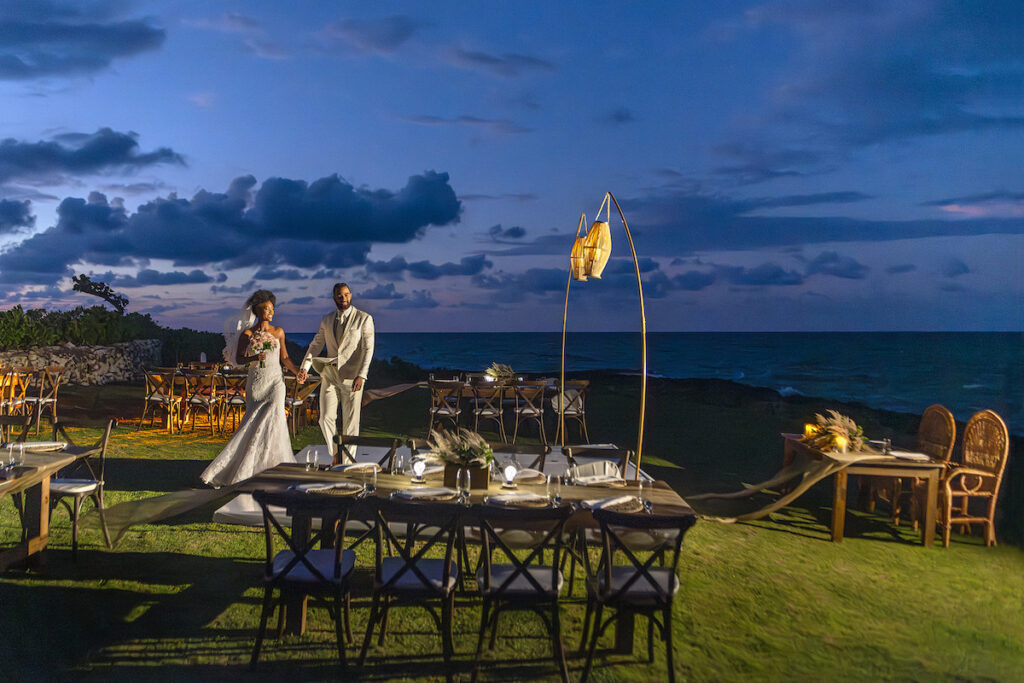outdoor reception setup with styled tables and couple approaching