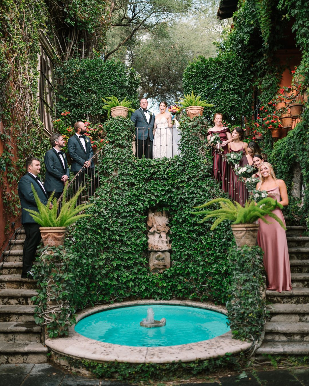 wedding party on stairs with lush greenery at Casa Hyder