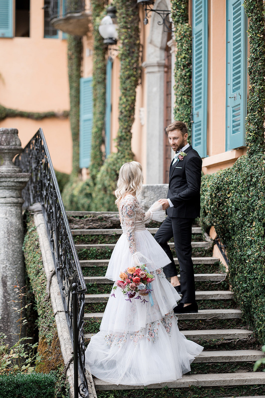 Wedding couple on steps of villa