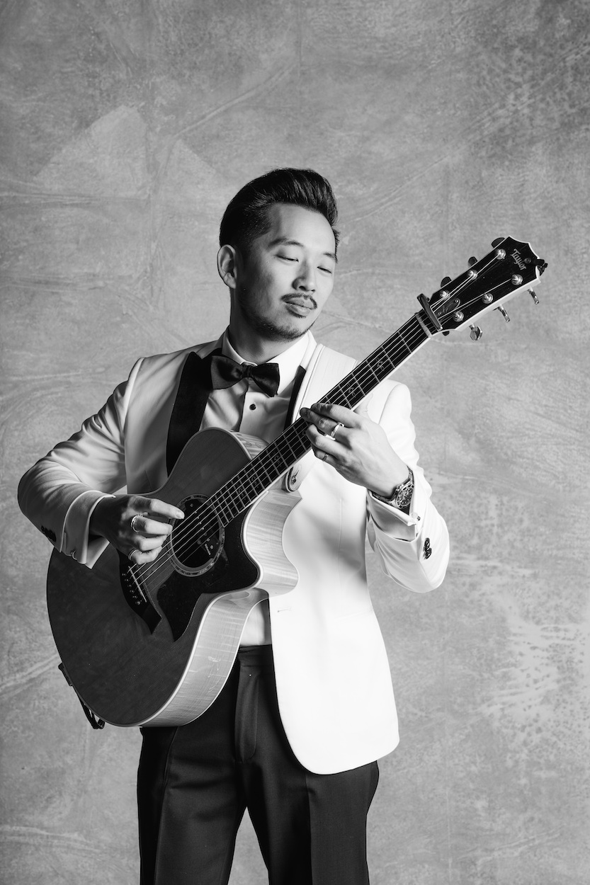 Wedding Guitarist Moses Lin plays in a tuxedo 