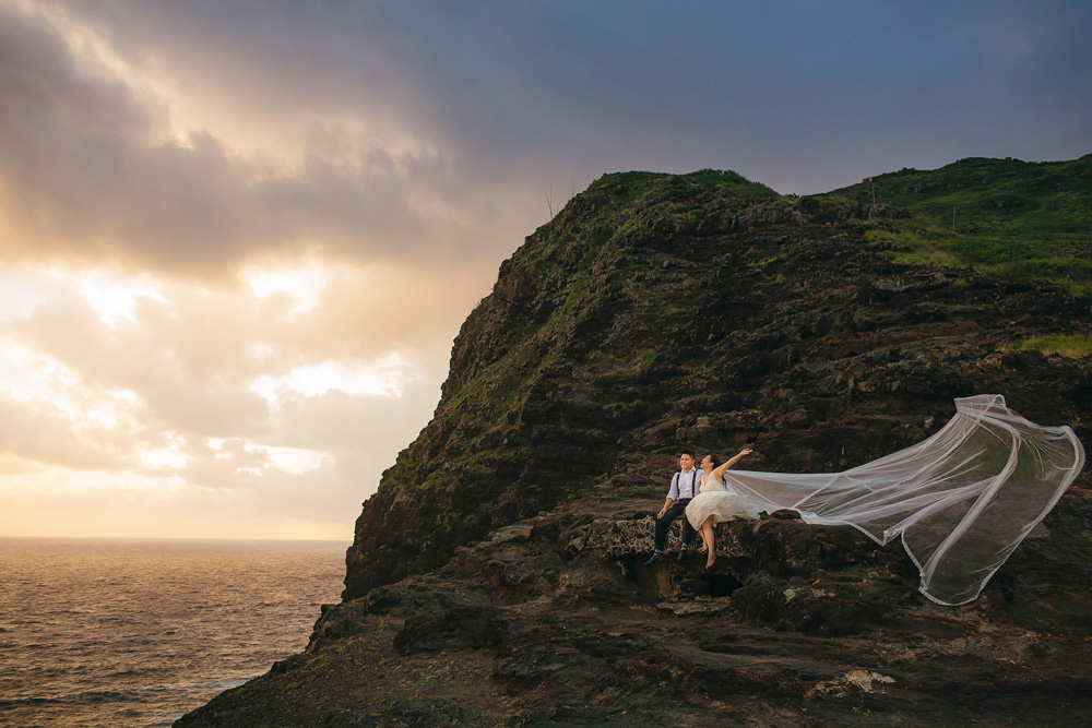 couple posing for a picture on a cliff in elopement photo