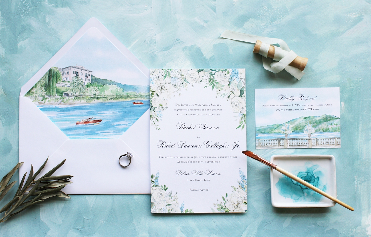 Custom watercolor wedding invitation with a painting, ring, and blue backdrop