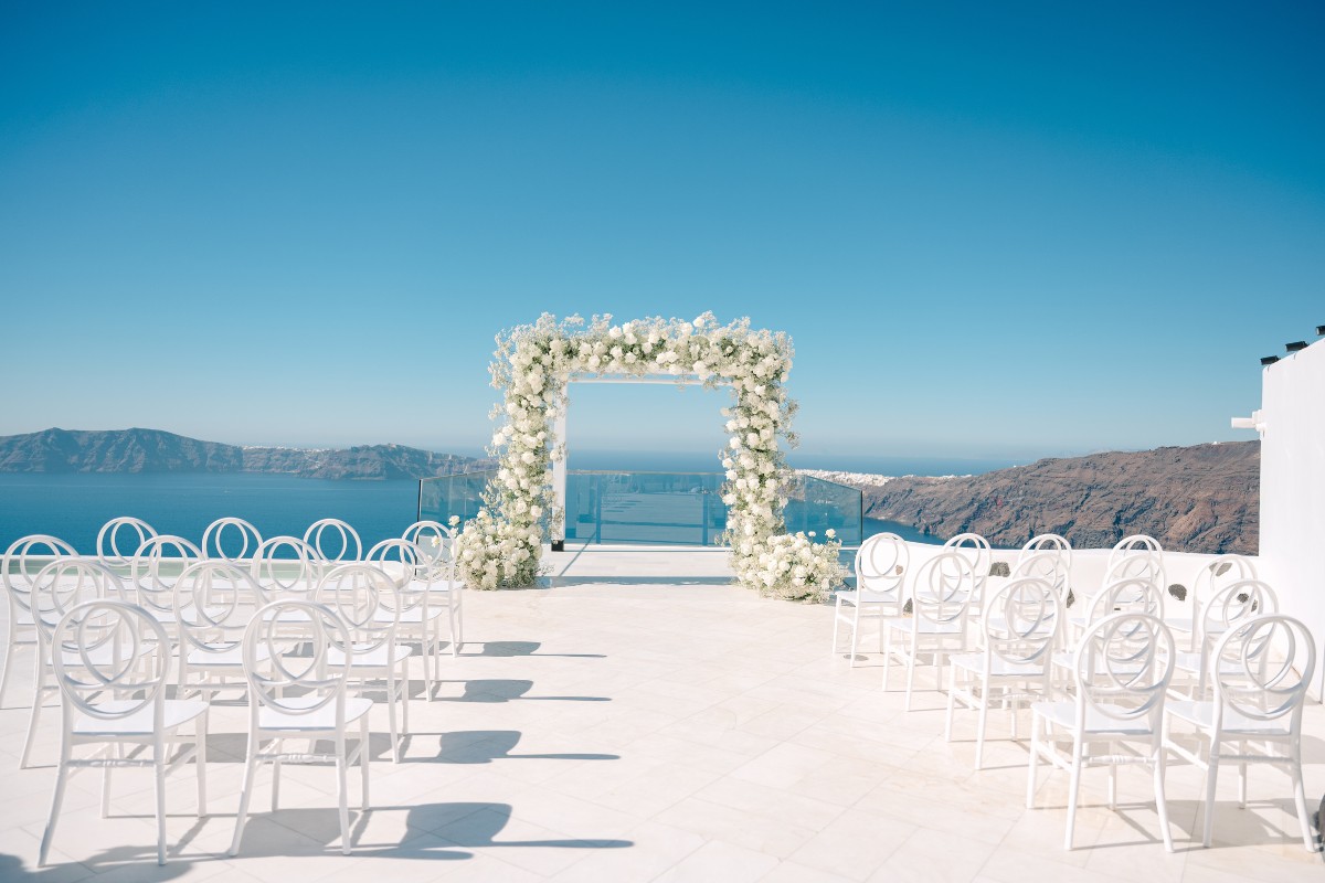 Santorini wedding ceremony with chairs and flowers