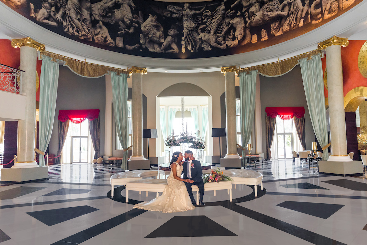 couple in foyer with dome and marble columns