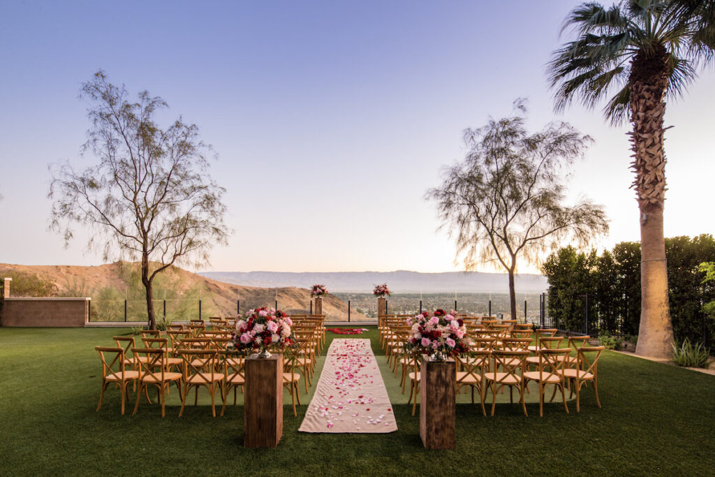 wedding venue decorated with florals and a hilly backdrop