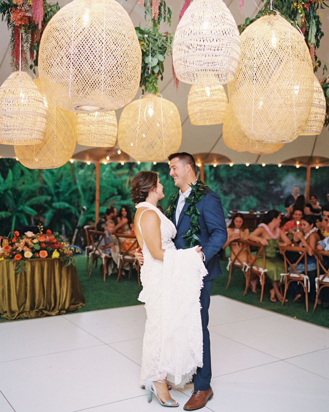 couple dance under lanterns at their maui reception