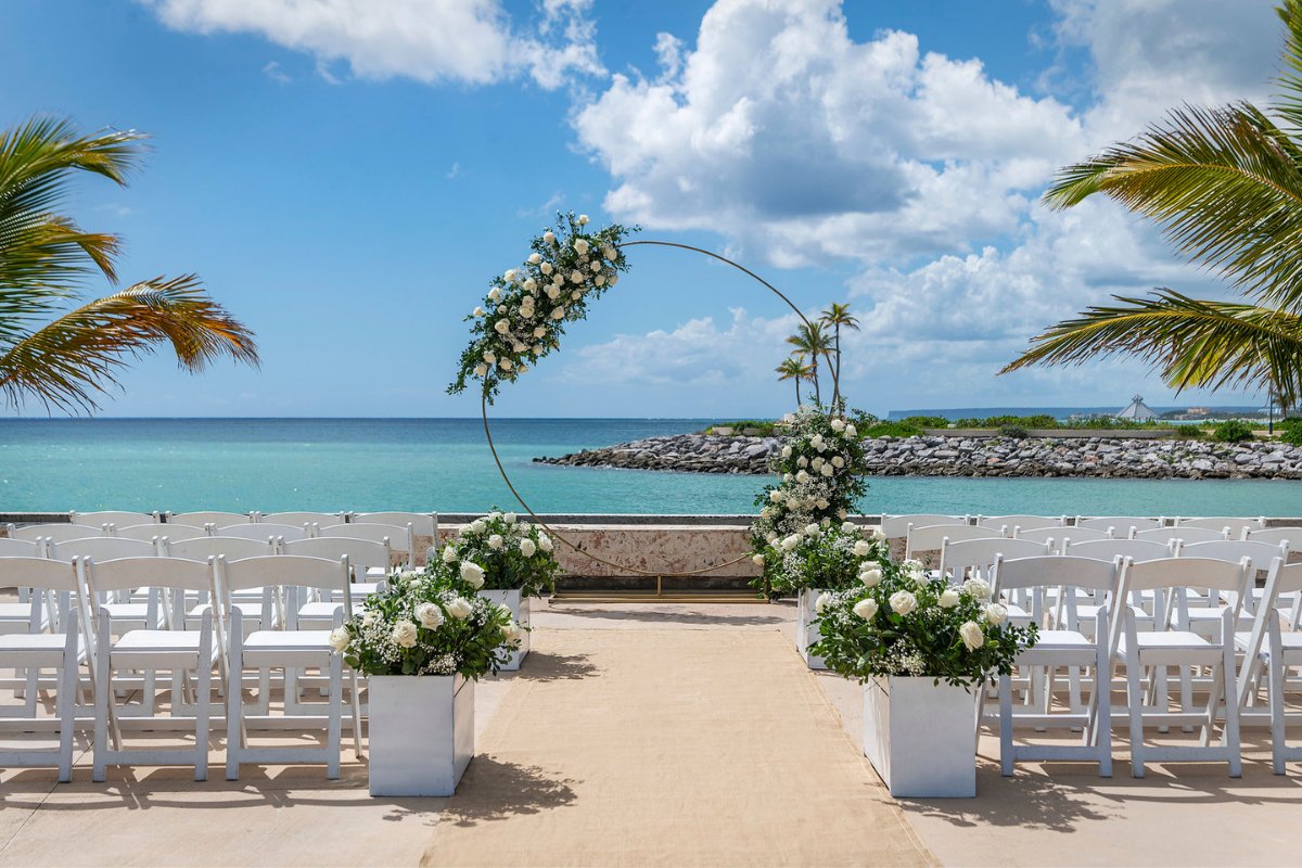 oceanside ceremony setup with white florals