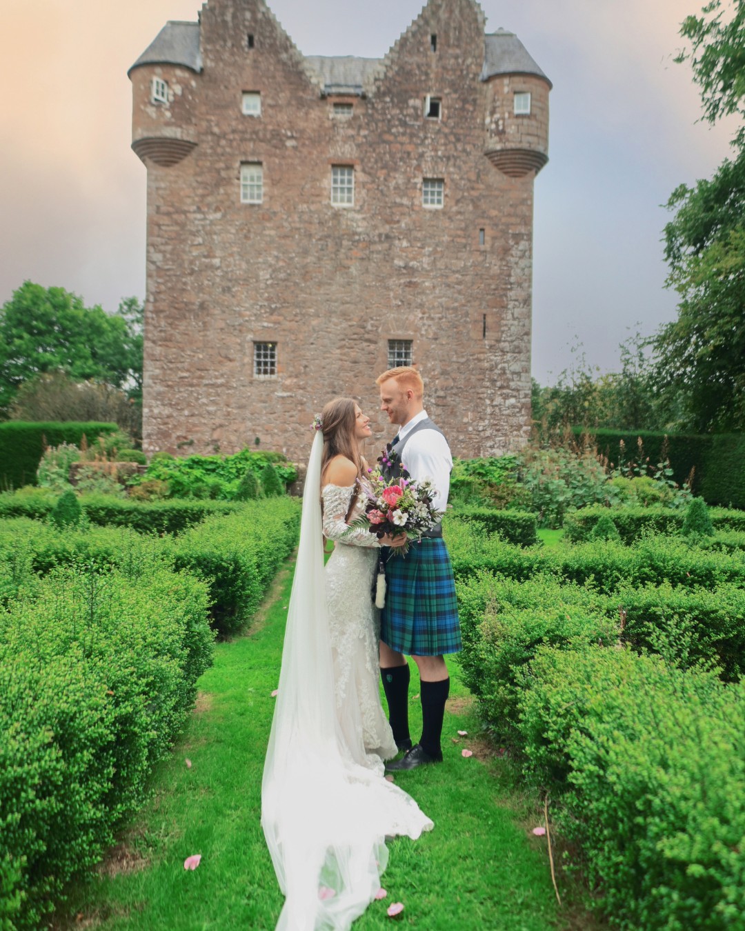 couple in gardens of castle in Scotland