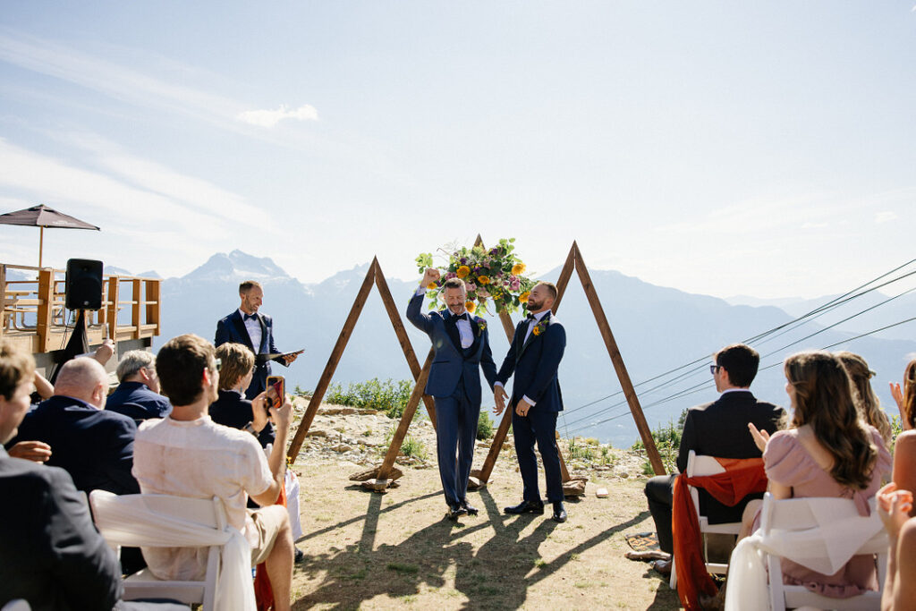 grooms stand at the altar of their mountain top ceremony
