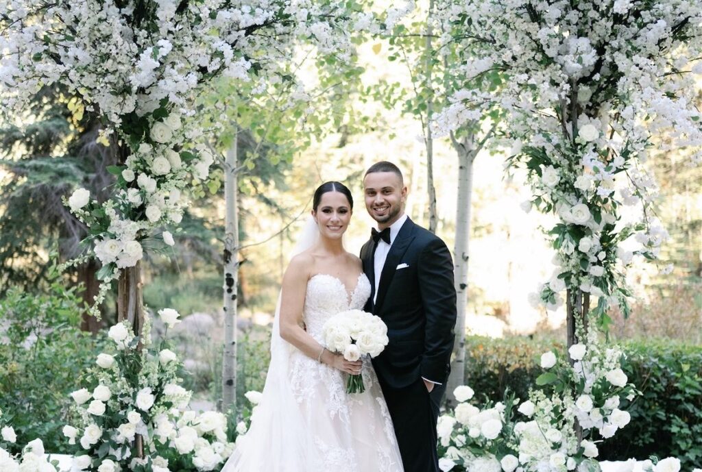 Tiffany and Daniel at altar with two white floral trees