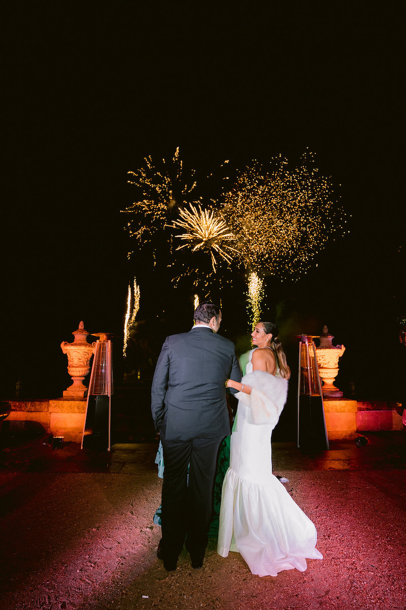 bride and groom enjoy fireworks at wedding reception in Paris countryside