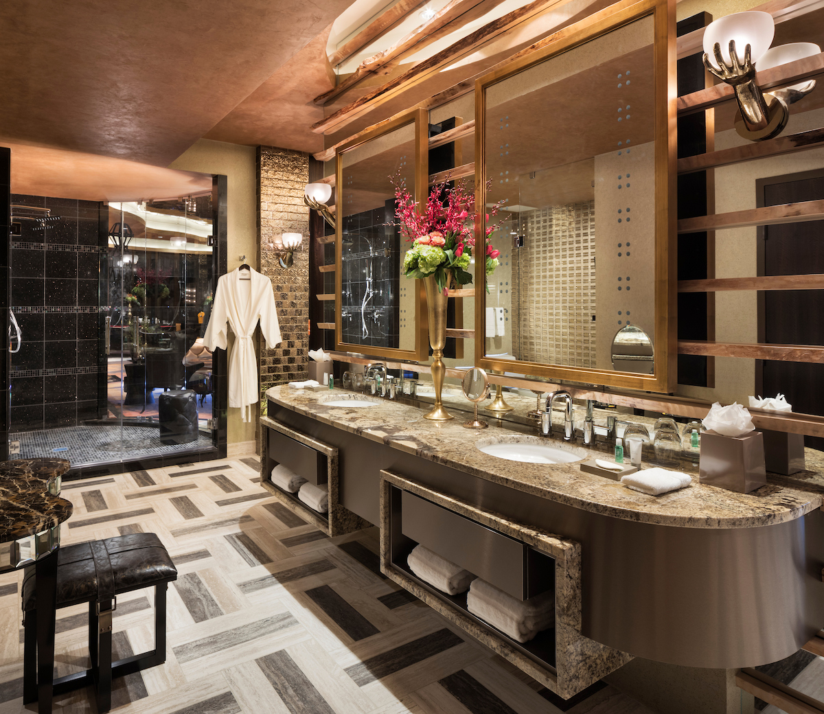 luxury bathroom with mirrored shower and double sinks with granite top