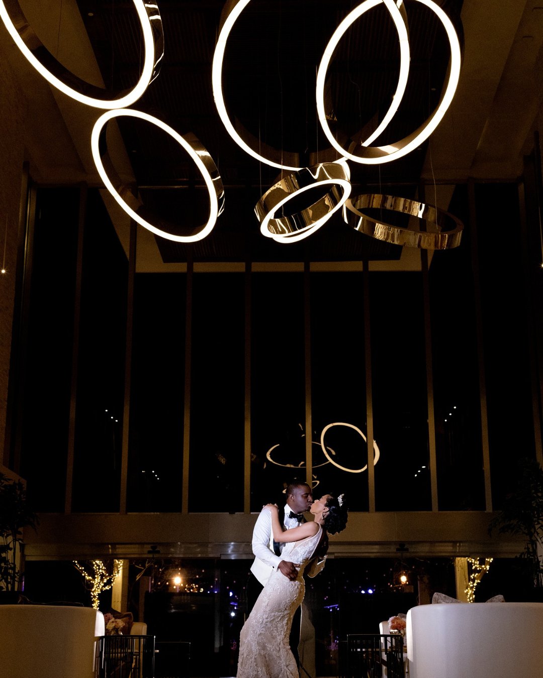 bride and groom kiss under lighting installation in LeBlanc Spa Resort Los Cabos