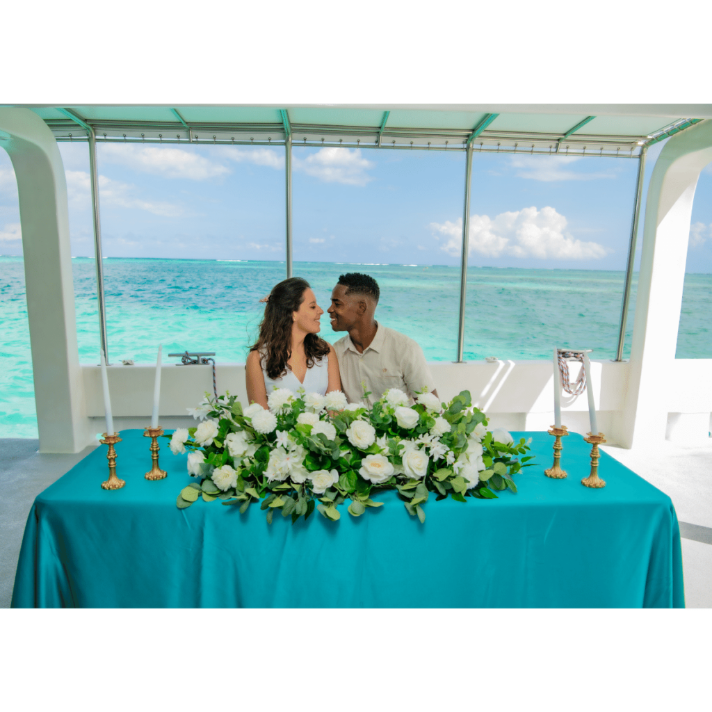 couple at blue table with ocean behind