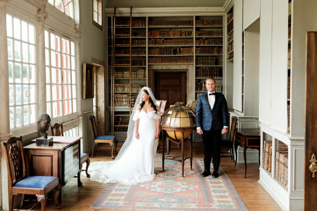 couple pose in old library before their wedding in Lisbon