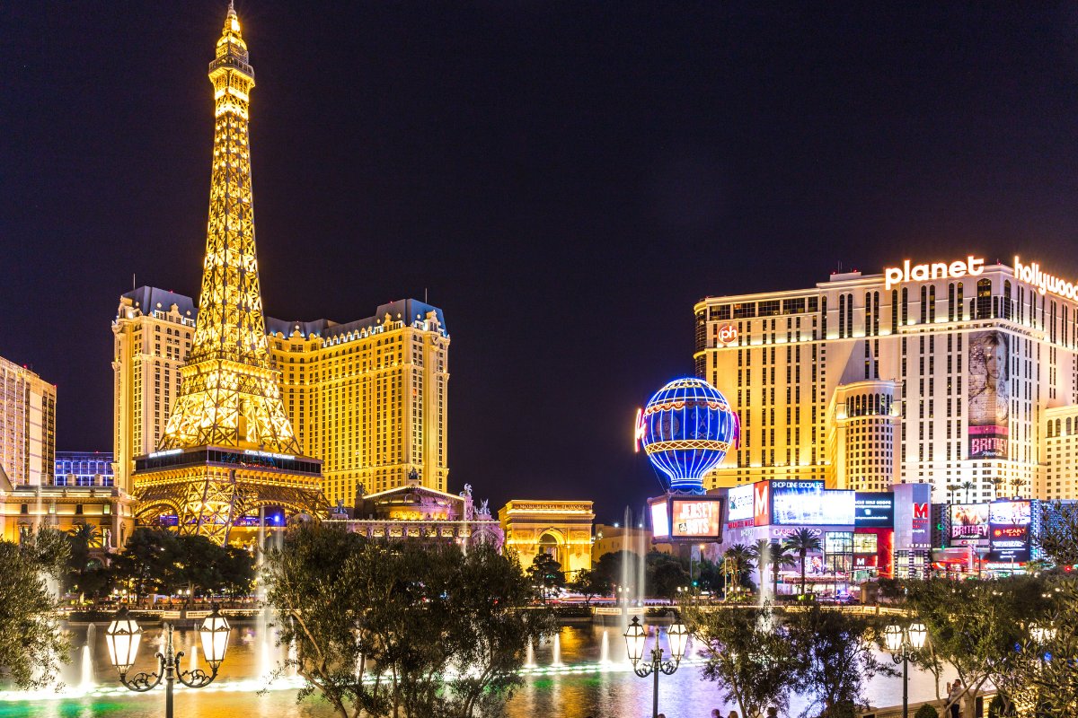 Las Vegas strip at night with Eiffel tower replica and lit up hotels