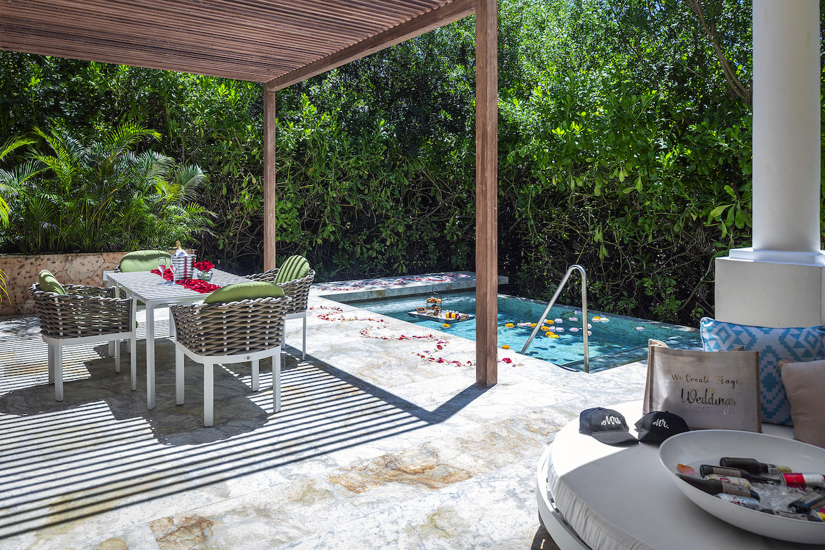 patio with a table and chairs next to a small plunge pool