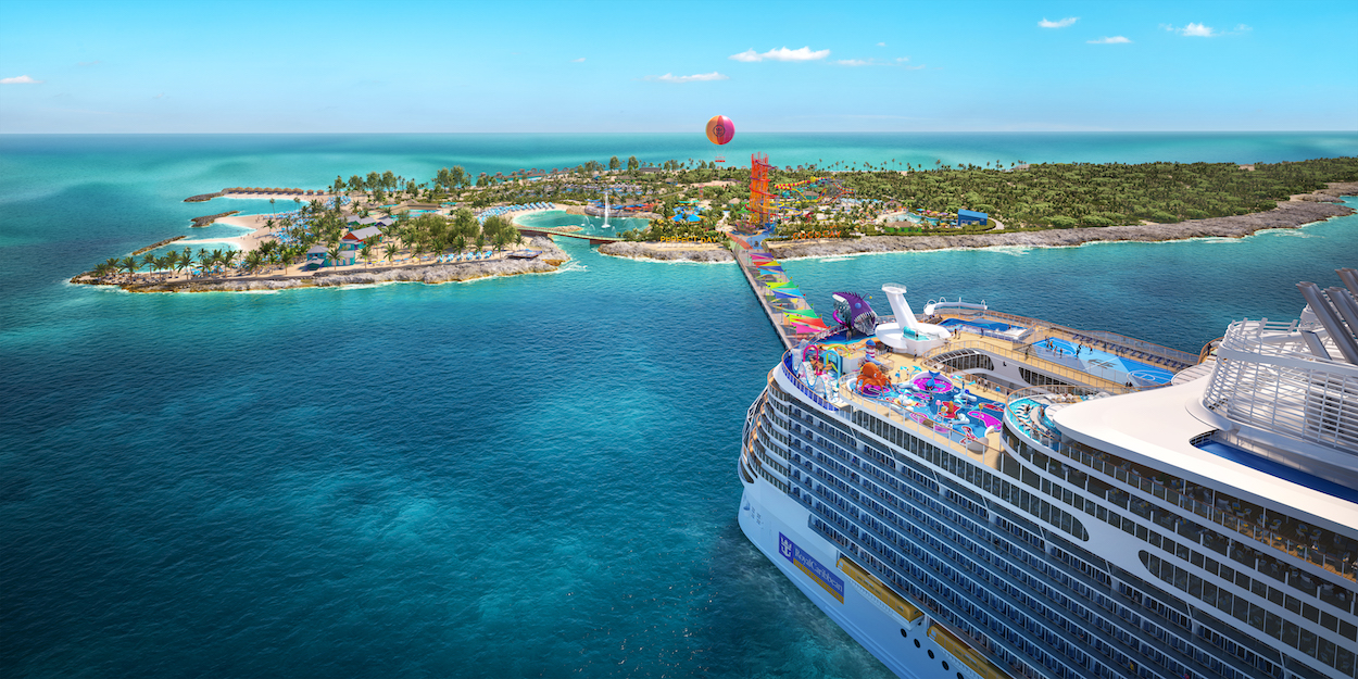 A cruise ship approaches a tropical island destination with a beach, palm trees, and a tall red tower. The scene is set under a clear blue sky.