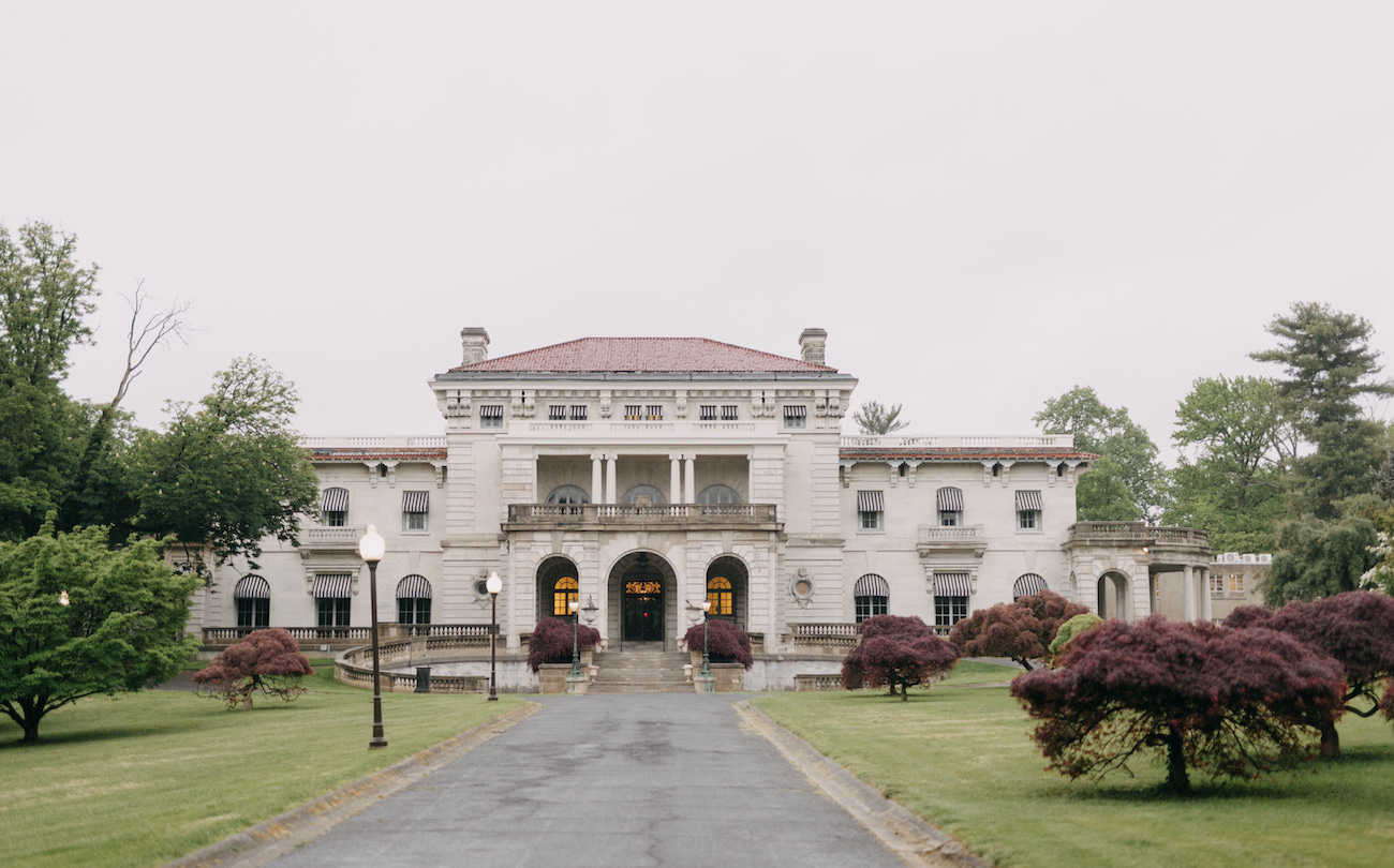 A grand estate with a driveway.