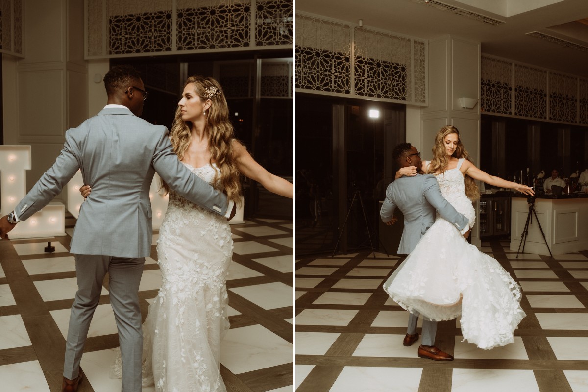 A couple in formal attire dances closely on a patterned floor in a dimly lit room.