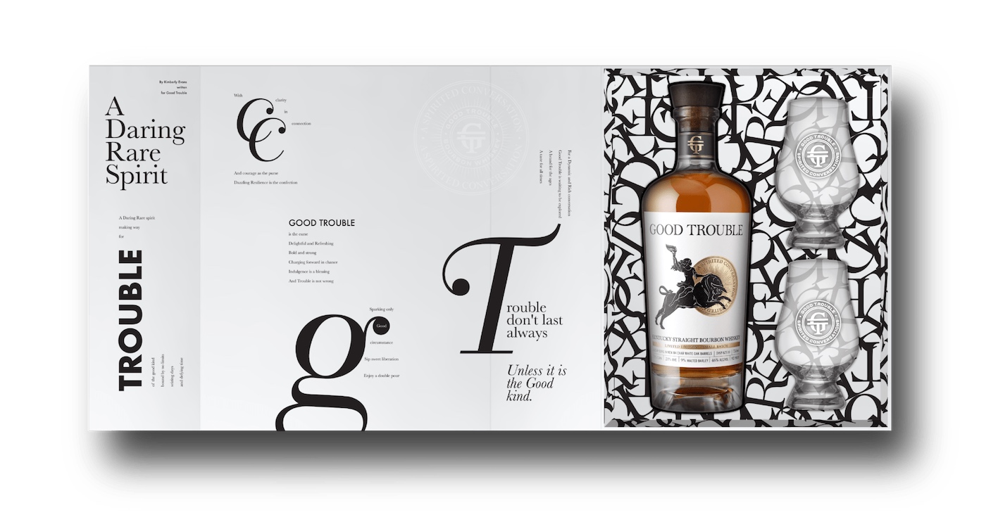 A boxed set containing a bottle of bourbon whisky and two whisky glasses, displayed against a decorative black and white background.