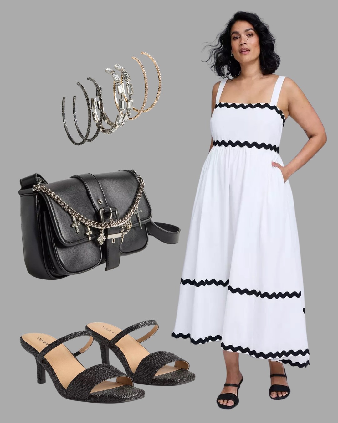 Woman wearing a white sleeveless dress with black trim, paired with black heeled sandals, a black shoulder bag with chain detail, and a set of hoop earrings.