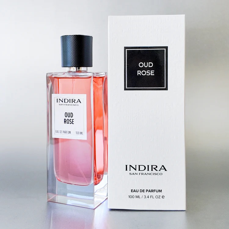 A bottle of Indira Oud Rose Eau de Parfum is placed next to its white box packaging, both labeled with the product name and brand.