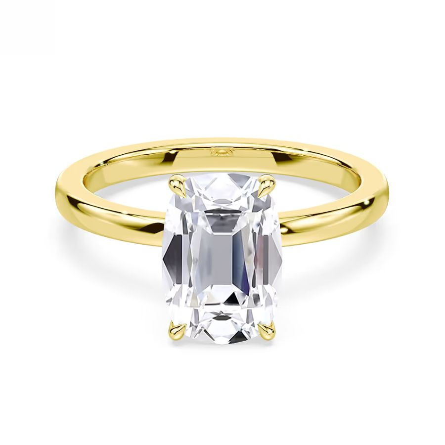 A gold ring featuring an emerald-cut clear gemstone set in a simple solitaire design.