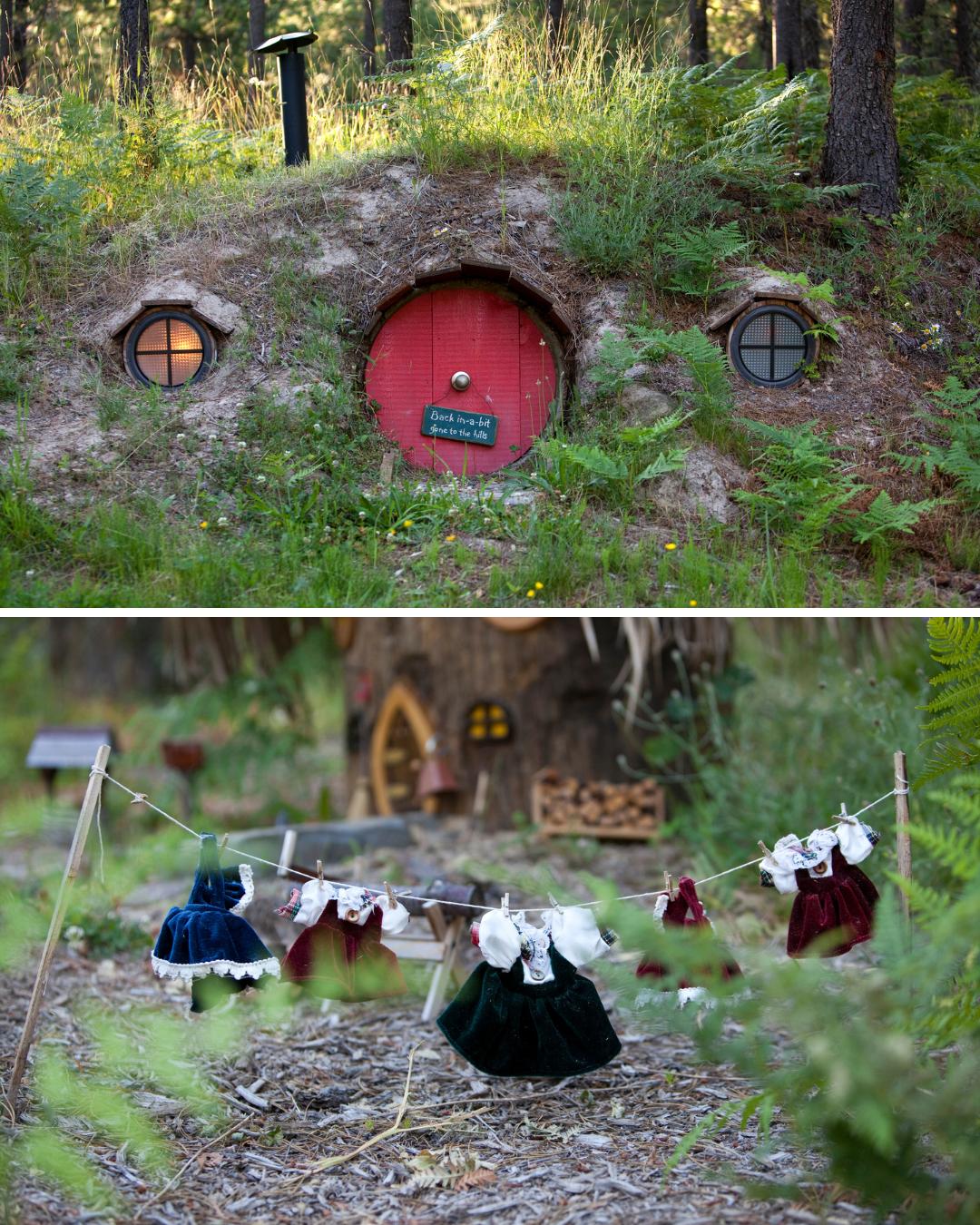 A small hobbit-style house with a round red door is set into a grassy hill; miniature dresses hang on a clothesline in a forested area nearby.