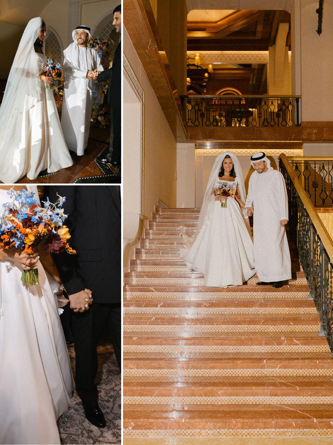 A bride in a white dress and veil walks with a man in traditional Middle Eastern attire; they hold hands and walk down a staircase, with guests nearby.