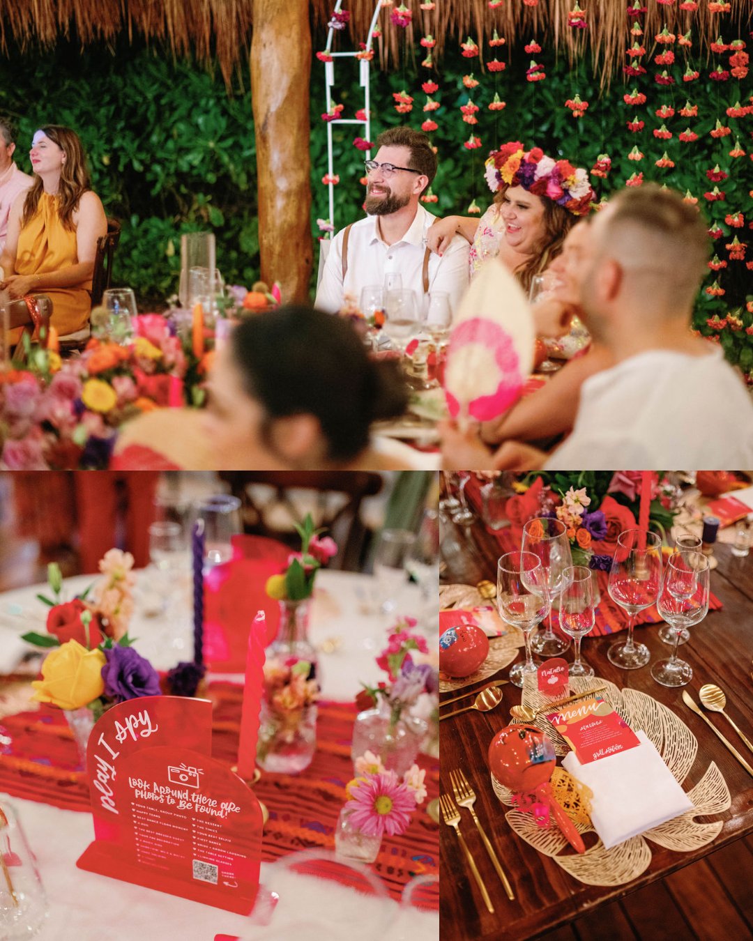 A group of people sits at a festively decorated table with colorful flowers, place settings, and menus at a vibrant indoor event or celebration.
