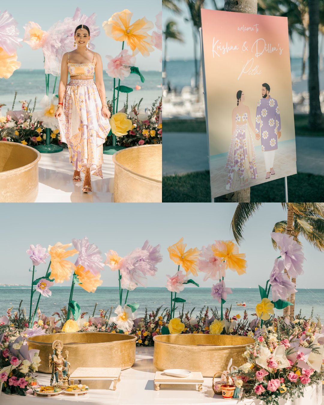 A woman in a floral dress stands by a decorative outdoor setup with large paper flowers, two round tubs, and a sign displaying illustrated figures near the ocean.