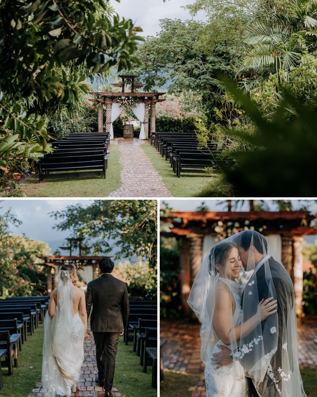 An outdoor wedding venue with rows of black benches, a stone path, and a couple walking and embracing under a wooden archway surrounded by greenery.