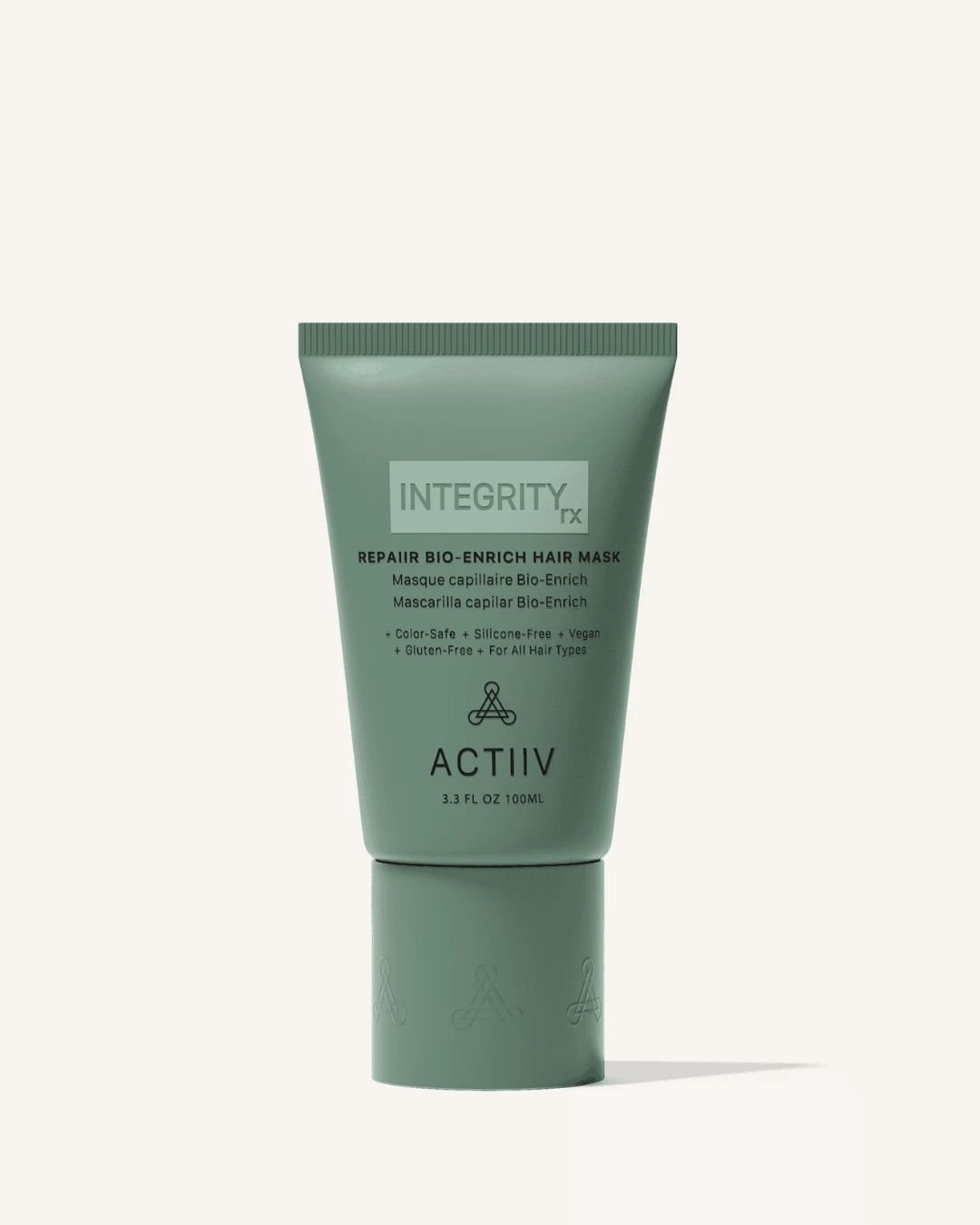 Green tube of ACTIIV Integrity Renew DHT-stimulated scalp mask for hair care, standing upright against a light background.